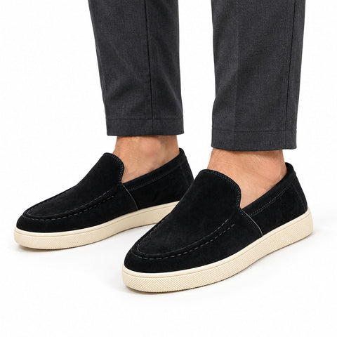 Ellison black men's casual slip-on shoes with stitched uppers and cream rubber soles, styled with dark trousers for a polished everyday look and discreet height boost
