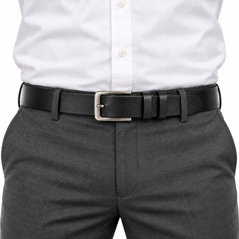 The Modern Belt in black leather with a silver buckle styled with a white shirt and gray trousers for a polished professional look