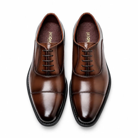Monarch polished light brown men's dress shoes with cap toes, open lacing and sleek black soles offering a discreet height boost