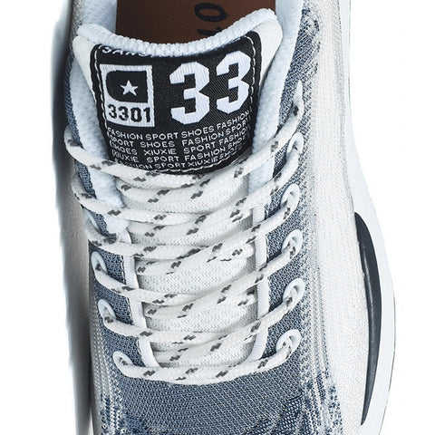Retro33 men's sneaker close up with a white and gray mesh upper white laces padded tongue and bold number 33 detail for a sporty look