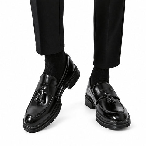 Sterling black polished leather tassel loafers with a discreet height boost and sturdy soles for sophisticated men's dresswear