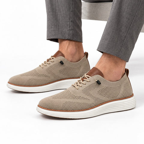 Strider camel knit men's casual shoes with white layered soles worn with gray trousers for a discreet height boost