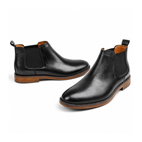 Wellington black leather Chelsea elevator boots with elastic side panels, pull tabs and a discreet height boost