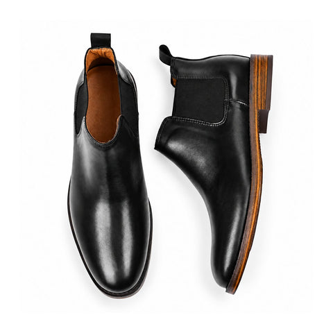 Wellington black leather ankle boots with elastic side panels and wood tone sole detail shown as a pair for polished casual wear and discreet height boost