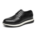 Black leather dress shoe with white sole on a white background