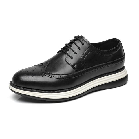 Black leather dress shoe with white sole on a white background