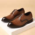 Brown leather dress shoes on a beige background