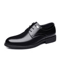 Black leather dress shoe on a white background
