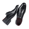 Pair of black leather dress shoes on a white background