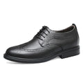 Black leather dress shoe on a white background