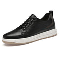 Black leather sneaker with white sole on a white background
