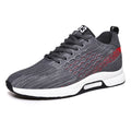 Gray athletic shoe with red accents on a white background