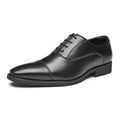 Black leather dress shoe on a white background