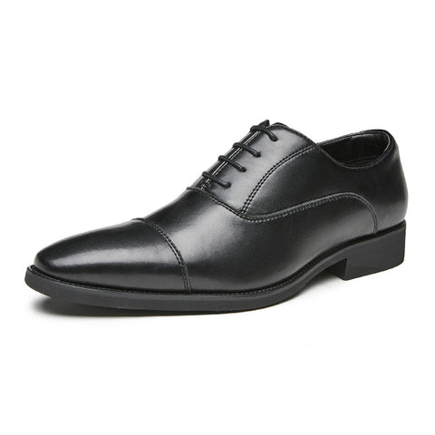 Black leather dress shoe on a white background