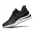 Black running shoe with white sole on a white background