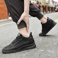 Person wearing black sneakers on a street with blurred background