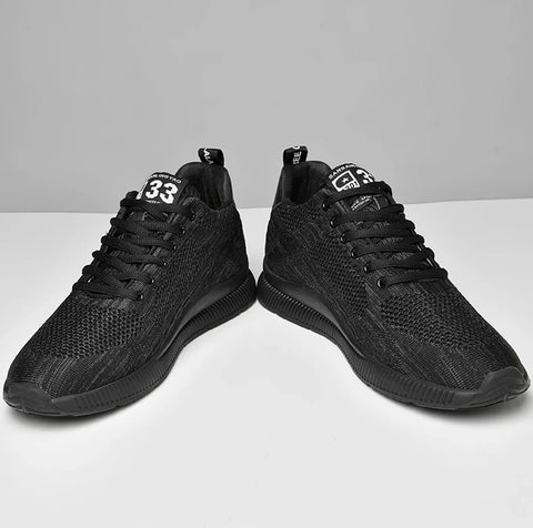Pair of black athletic shoes on a white background