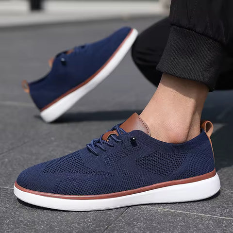 Strider men's sneakers in navy blue with brown accents and white soles, featuring a modern design and discreet height boost for comfortable elevation.