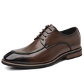 Brown leather dress shoe on a white background