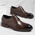 Pair of brown dress shoes on a white background