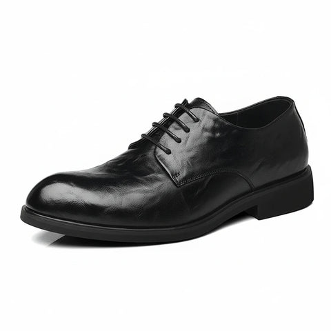 Black leather dress shoe on a white background.