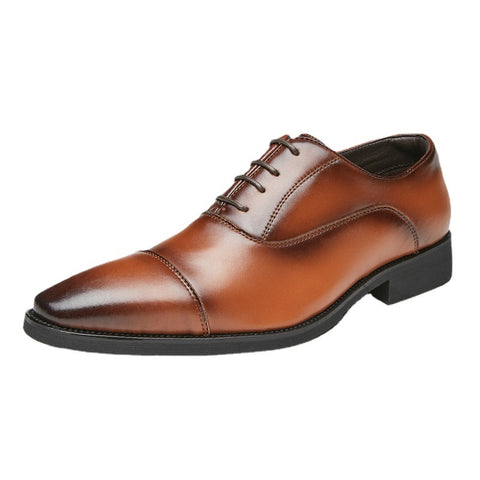Brown leather dress shoe on a white background