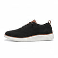 Black knitted men's sneaker with white sole and brown accents, designed as discreet height boost elevator shoes called Strider for comfortable modern casual wear.