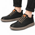 Altura black men's casual shoes with moc toe stitching tan laces and textured raised soles worn with cuffed black jeans