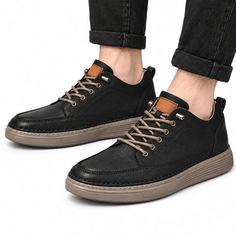 Altura black men's casual shoes with moc toe stitching tan laces and textured raised soles worn with cuffed black jeans