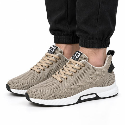 Ascend33 beige mens sneakers with textured knit uppers cushioned white soles and a discreet height boost styled with black joggers