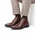 Ashford mens dress boots in polished brown leather with lace up fronts and a discreet height boost styled with tailored trousers