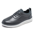 Prescott men's sneaker-style elevator shoe in black leather with perforated detailing, comfortable insoles, and a discreet height boost for a modern, elevated appearance.