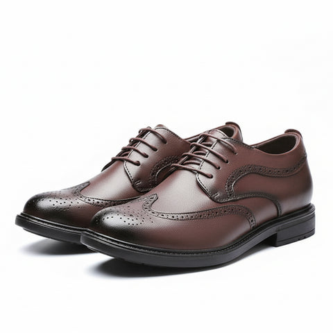 Pair of brown dress shoe with designs on a white background.