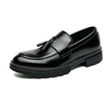 Black polished leather dress shoe with tassel detail and sturdy rubber sole, designed for discreet height boost and comfort, labeled Sterling by Modern Elevation.