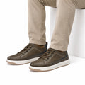 Brooklyn elevated casual shoes in brown leather with contrast stitching and white soles shown on a model for a modern look with a discreet height boost