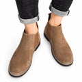 Chelsea brown suede mens casual ankle boots with sleek rounded toes and a discreet height boost worn with cuffed jeans