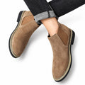Chelsea brown suede casual elevator boots with elastic side panels and cushioned soles styled with cuffed dark denim for a discreet height boost