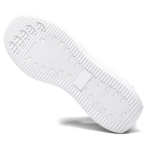 Sole of the Cityline sneaker in white, showing the textured grip pattern and the clean profile that keeps the hidden lift discreet.