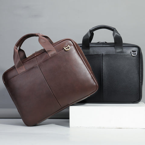 Brown and black leather briefcases on a gray background