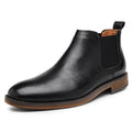 Black leather Wellington ankle boot with discreet height boost, featuring elastic side panels and a wooden sole, designed for comfort and stylish elevation.