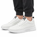 Elevate33 white men's sneakers with textured knit uppers and cushioned soles shown with dark joggers for a clean casual look and discreet height boost