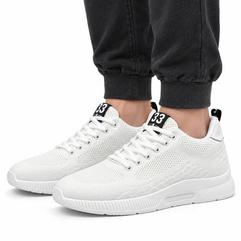 Elevate33 white men's sneakers with textured knit uppers and cushioned soles shown with dark joggers for a clean casual look and discreet height boost