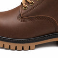 Explorer brown leather lace-up boot with brass eyelets, a rugged lug sole and a discreet height boost