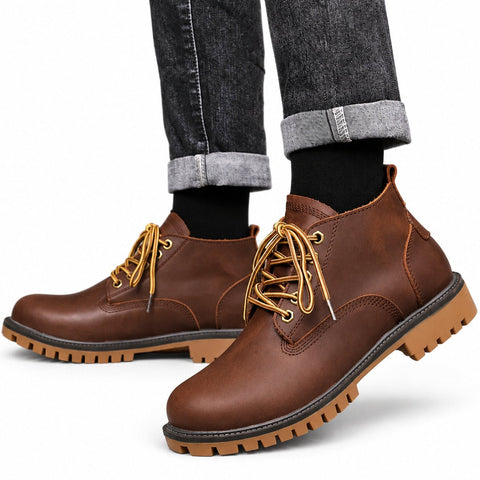 Explorer brown leather casual boots with gold laces and rugged lug soles styled with cuffed jeans for a discreet height boost