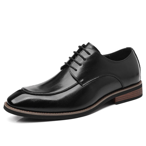 Black leather dress shoe on a white background