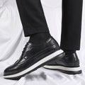 Black Hartford men's dress shoes with brogue detailing and white soles, featuring a hidden internal lift for a discreet height boost and everyday comfort.