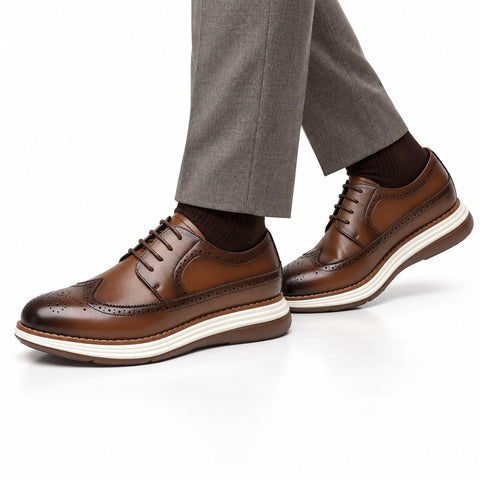 Hartford light brown leather men's dress shoes with brogue detailing and a discreet height boost styled with tailored trousers