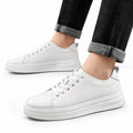 Hawthorn white casual elevator shoes with clean lace up styling and thick soles shown with cuffed black jeans for a discreet height boost and modern everyday look