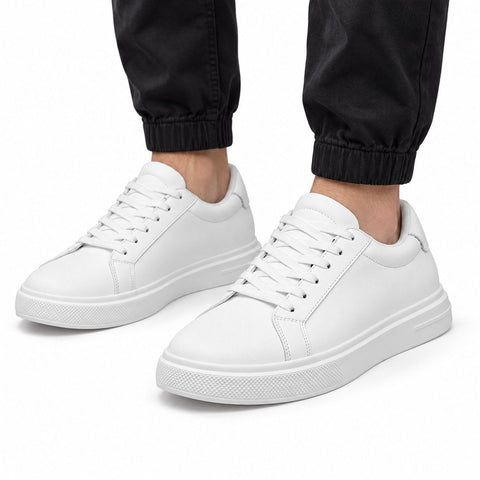 Heritage white mens casual sneakers with clean uppers cushioned soles and a discreet height boost styled with black joggers