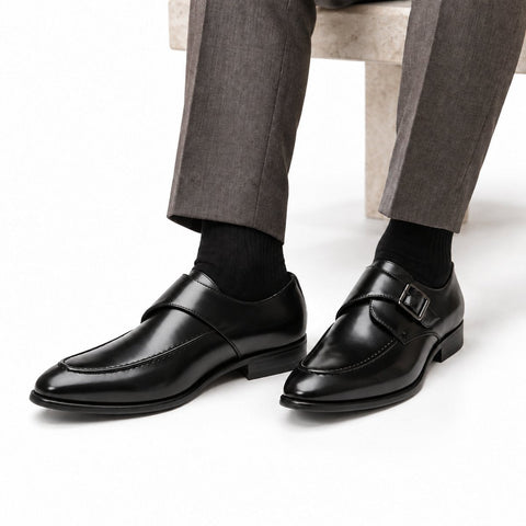 Lennox black leather mens dress shoes with a sleek polished finish and discreet height boost styled with tailored gray trousers